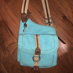 A turquoise fabric Fossil purse from an outlet store